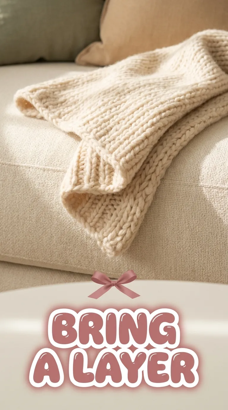Close-up of a soft wool wrap showing its weave and folded edge on a light surface